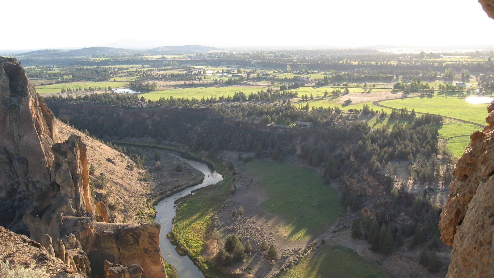 The Crooked River winding through the canyon at Smith Rock State Park north of Redmond, with the farmland of the Central Oregon plateau beyond