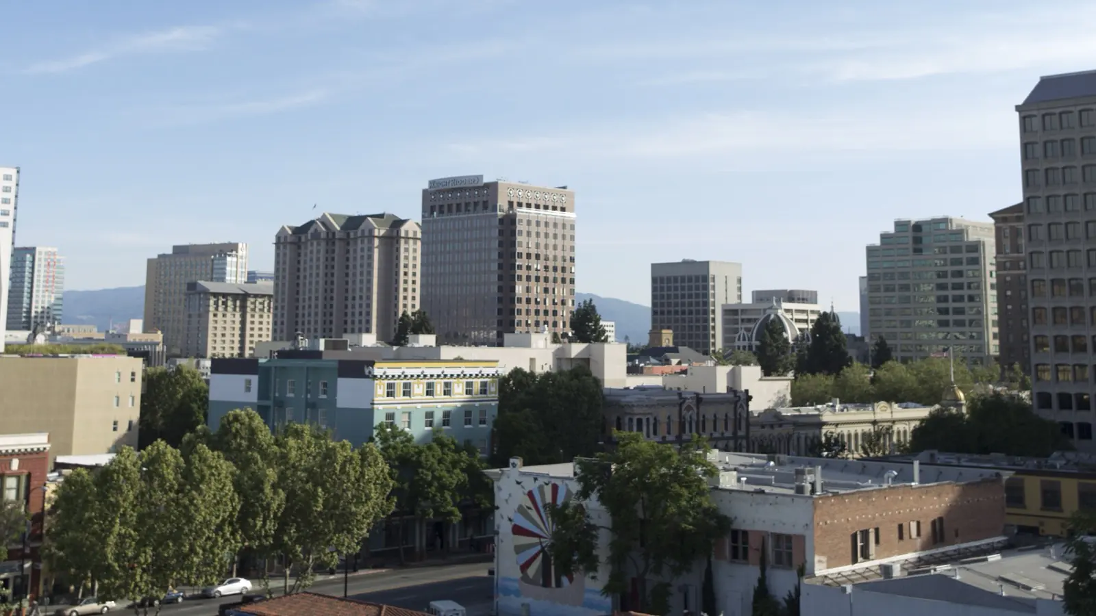 Downtown San Jose at midday, office towers rising behind the low-rise blocks of the city center